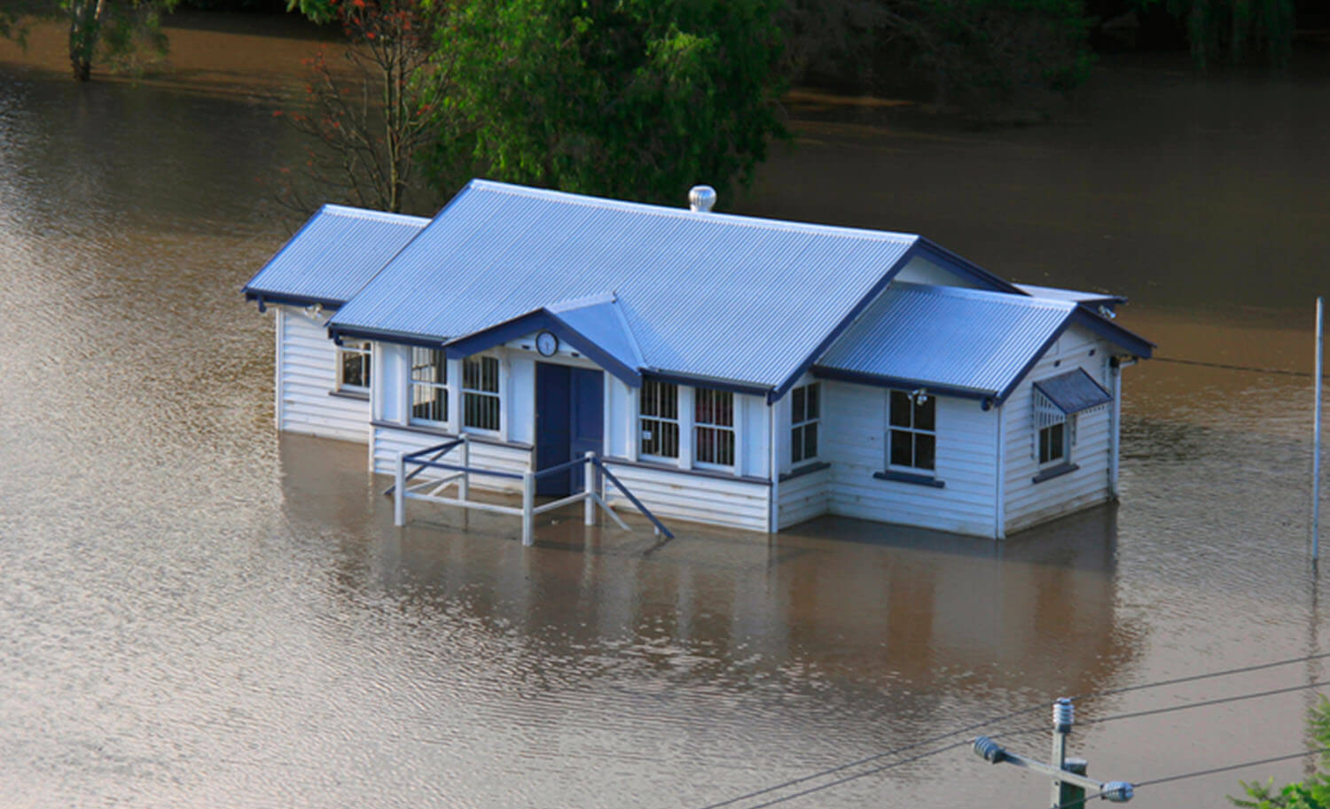 flooded house entirely surrounded by water and cut off from land